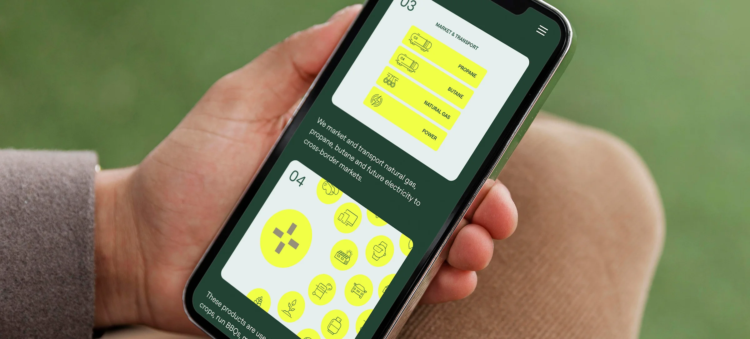 Hand holding a mobile device showing Steel Reef's emissions-to-energy practice infographic.